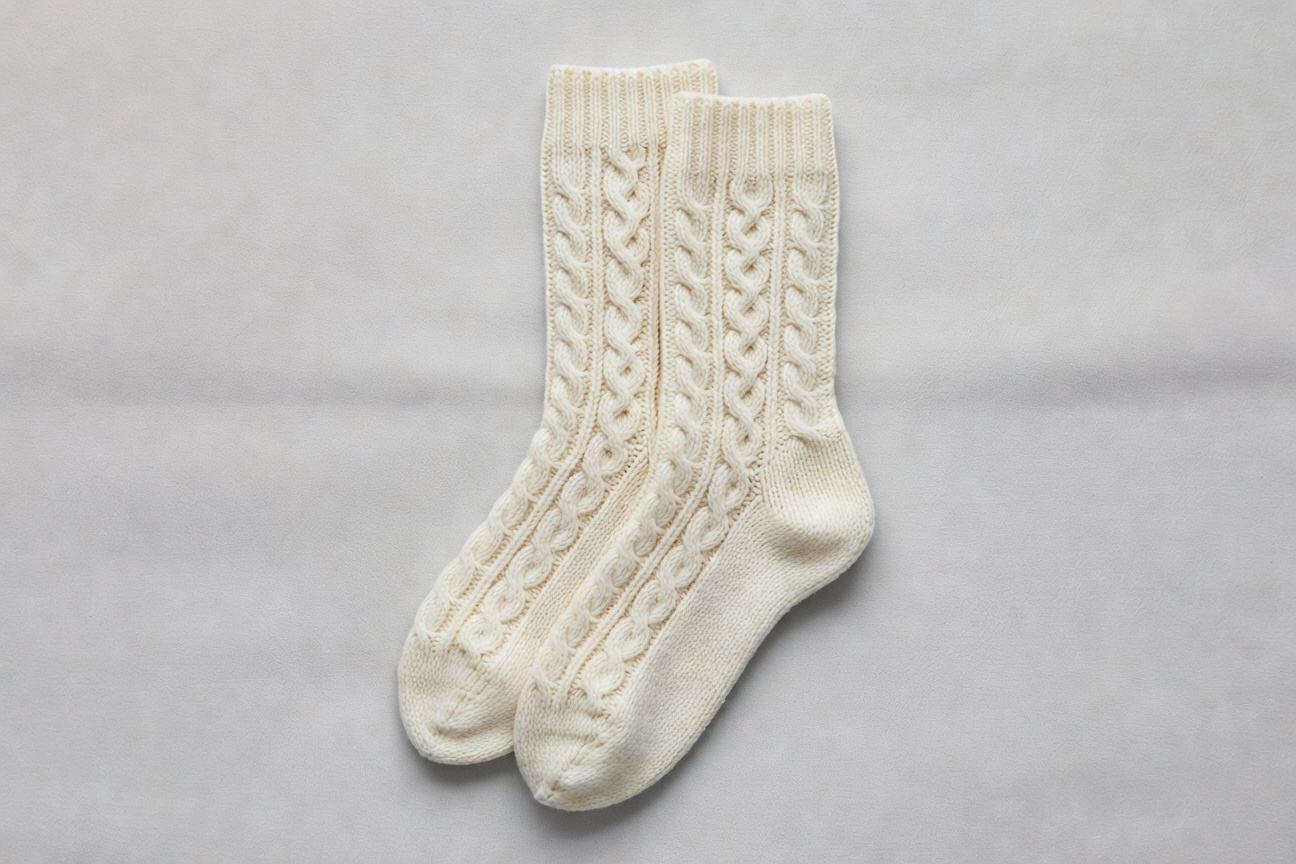 Cream colored traditional cable knit socks